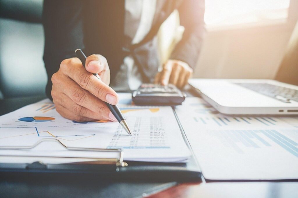 Accountant calculating figures and reviewing financial documents for bookkeeping services