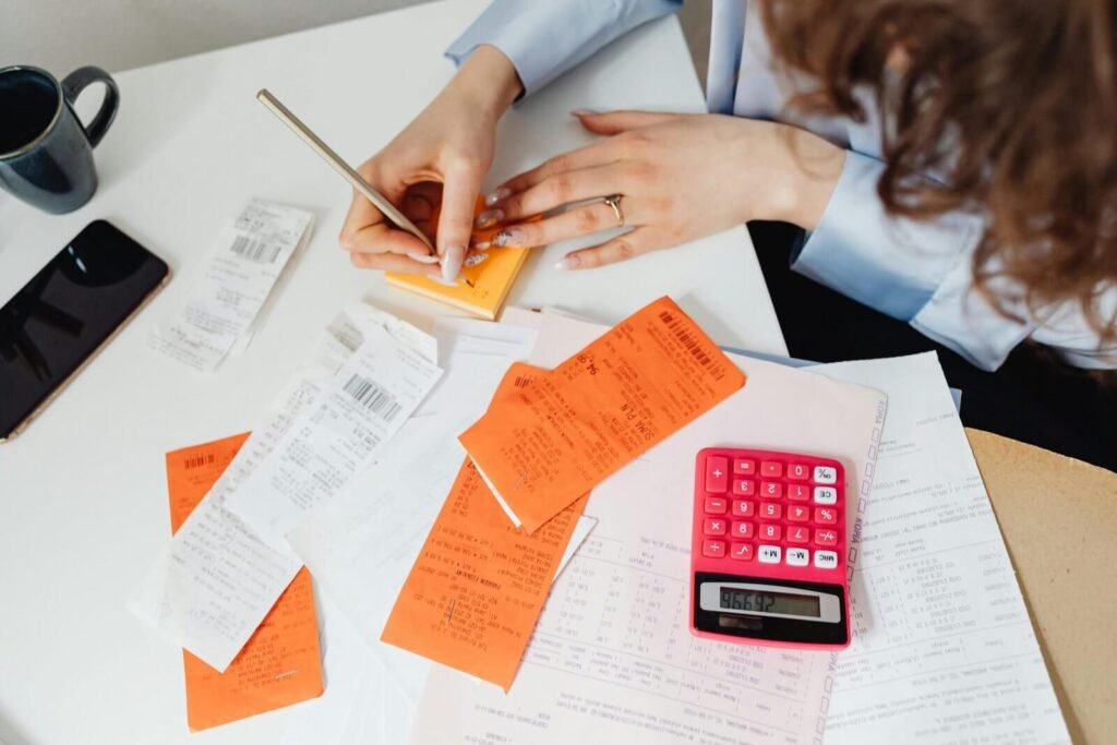 Accountant organizing receipts and financial paperwork for annual accounts preparation